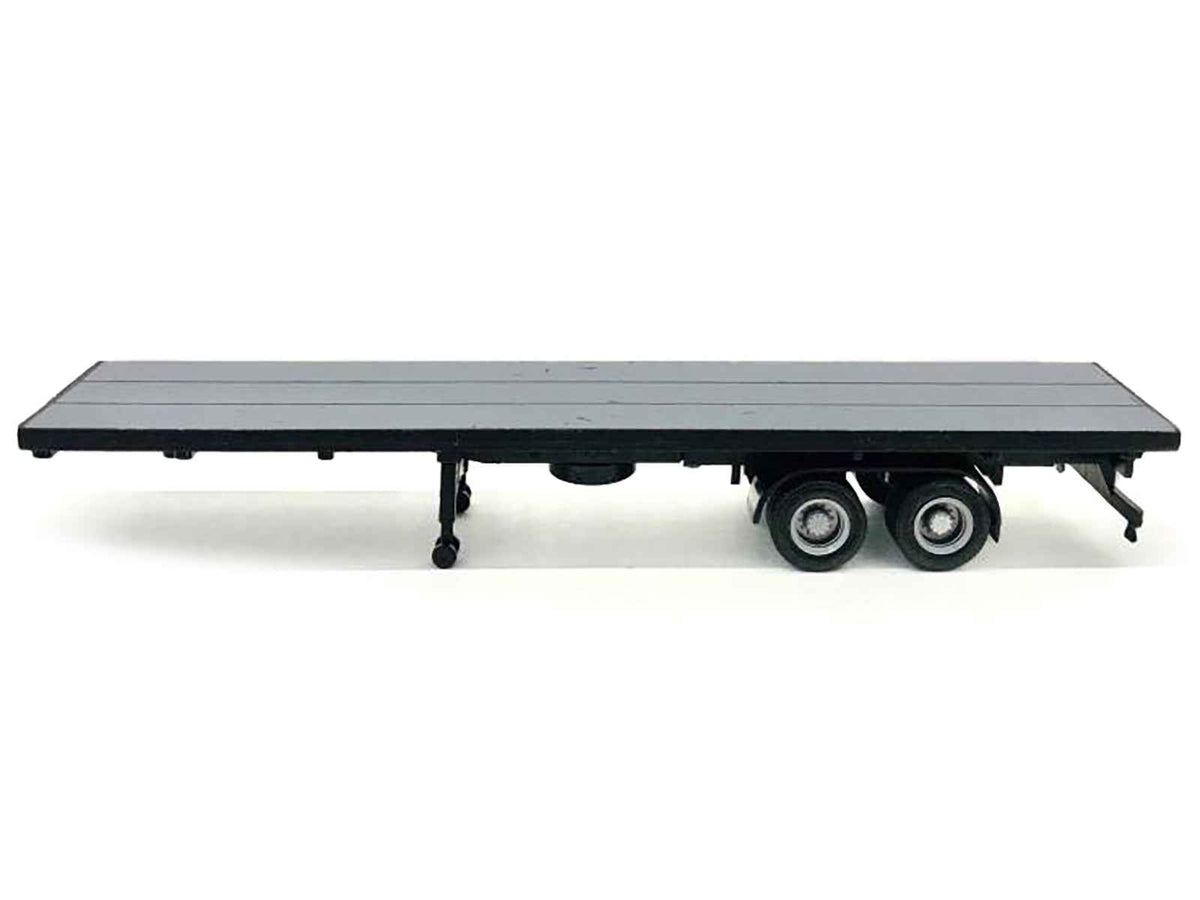 Gray 40ft flatbed trailer plastic model by Miniature Motors, detailed HO scale accessory for model train layouts.