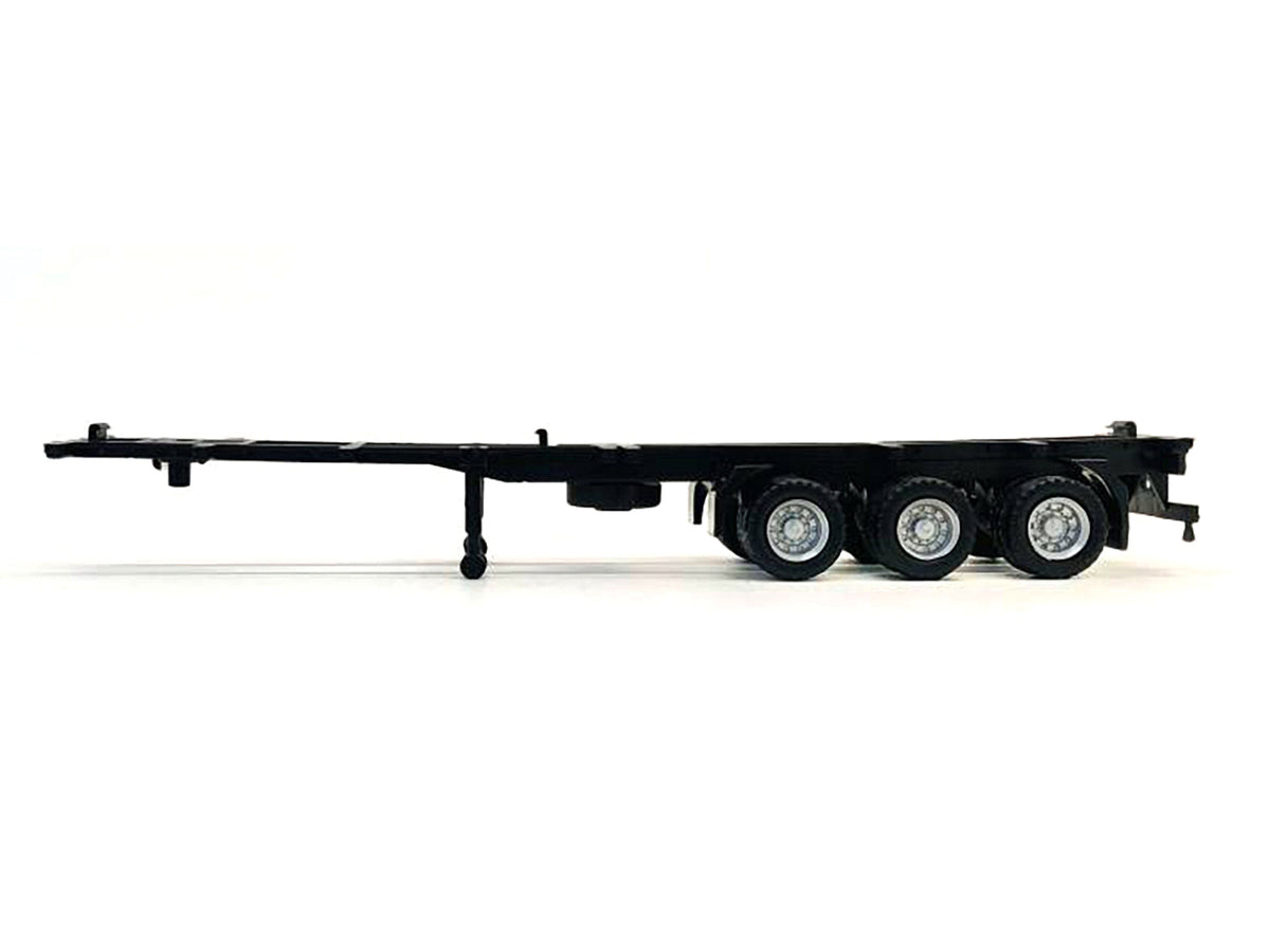 Plastic model container chassis for 3-axle 40ft trailer in HO scale, by Miniature Motors, detailed accessory for model trains.