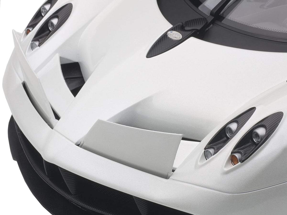White Pagani Huayra 1/12 scale model car by Autoart, detailed miniature from Miniature Motors, shown from a side angle.