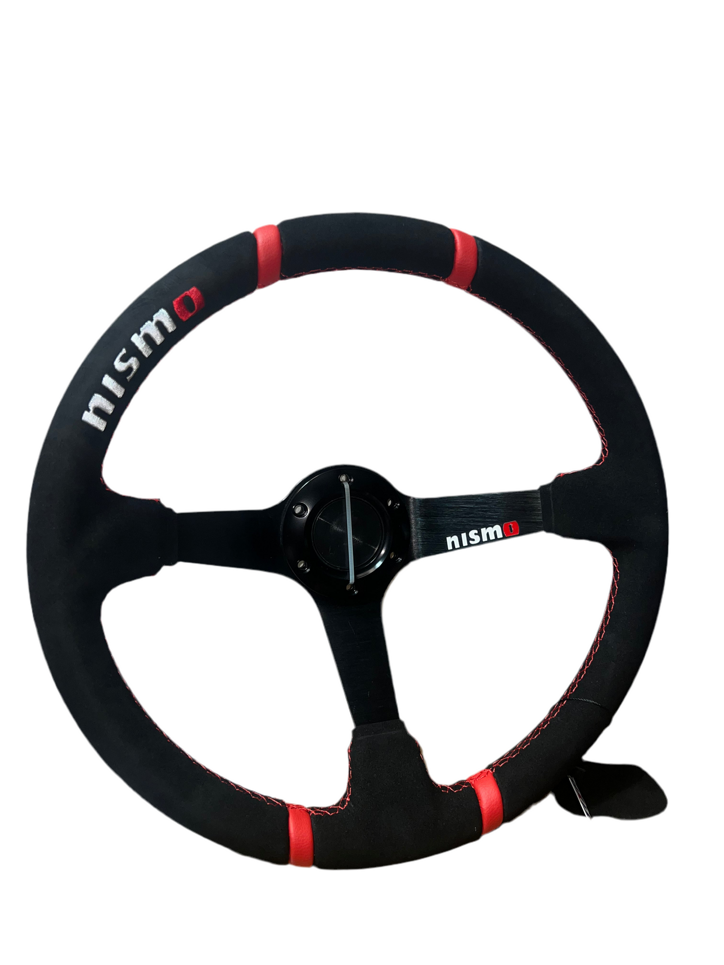 Nismo steering wheel by Speedzone Performance LLC with black grip and silver accents, sport-oriented design for racing vehicles.