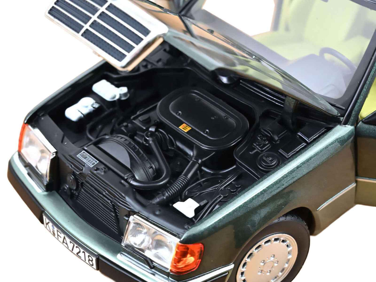 Miniature 1/18 Mercedes-Benz 230 E diecast model car in Night Green Metallic with green interior by Norev