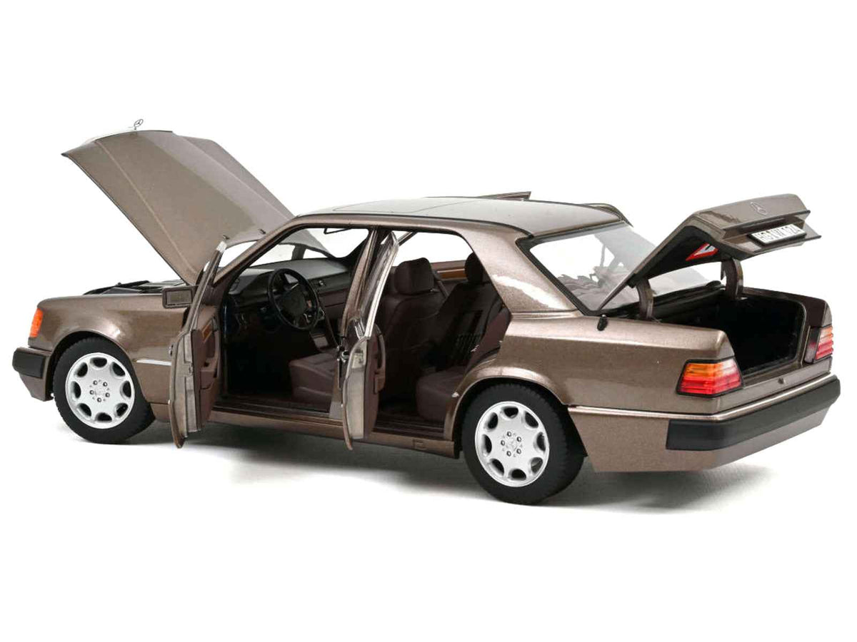 Miniature Motors 1/18 Mercedes-Benz 500 E diecast model car in Impala Brown Metallic by Norev, detailed collectible vehicle.
