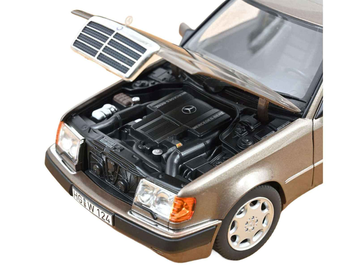 Miniature Motors Mercedes-Benz 500 E diecast model car in Impala Brown Metallic, 1/18 scale by Norev, detailed collectible display piece.