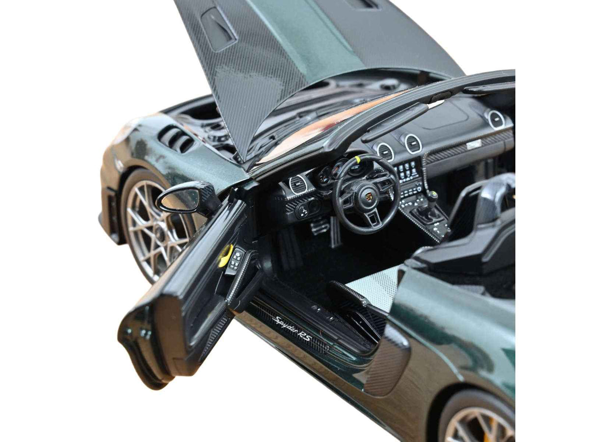 Miniature Porsche 718 Spyder RS Weissach Pack diecast model car in Forest Green Metallic with carbon hood stripes, 1/18 scale by Norev.