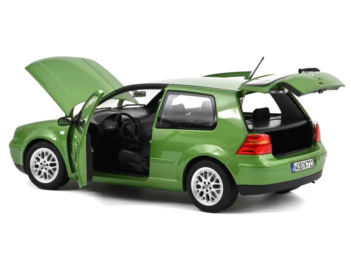 Green metallic 1998 Volkswagen Golf GTI diecast model car by Norev, detailed miniature vehicle displayed from side view.