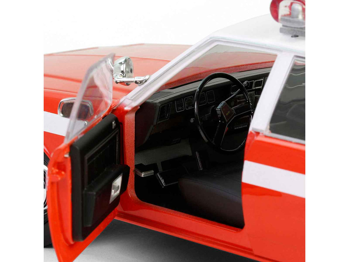 1987 Chevrolet Caprice 9C1 FDNY diecast model car by Greenlight, red with white top and stripes, part of the Artisan Collection.