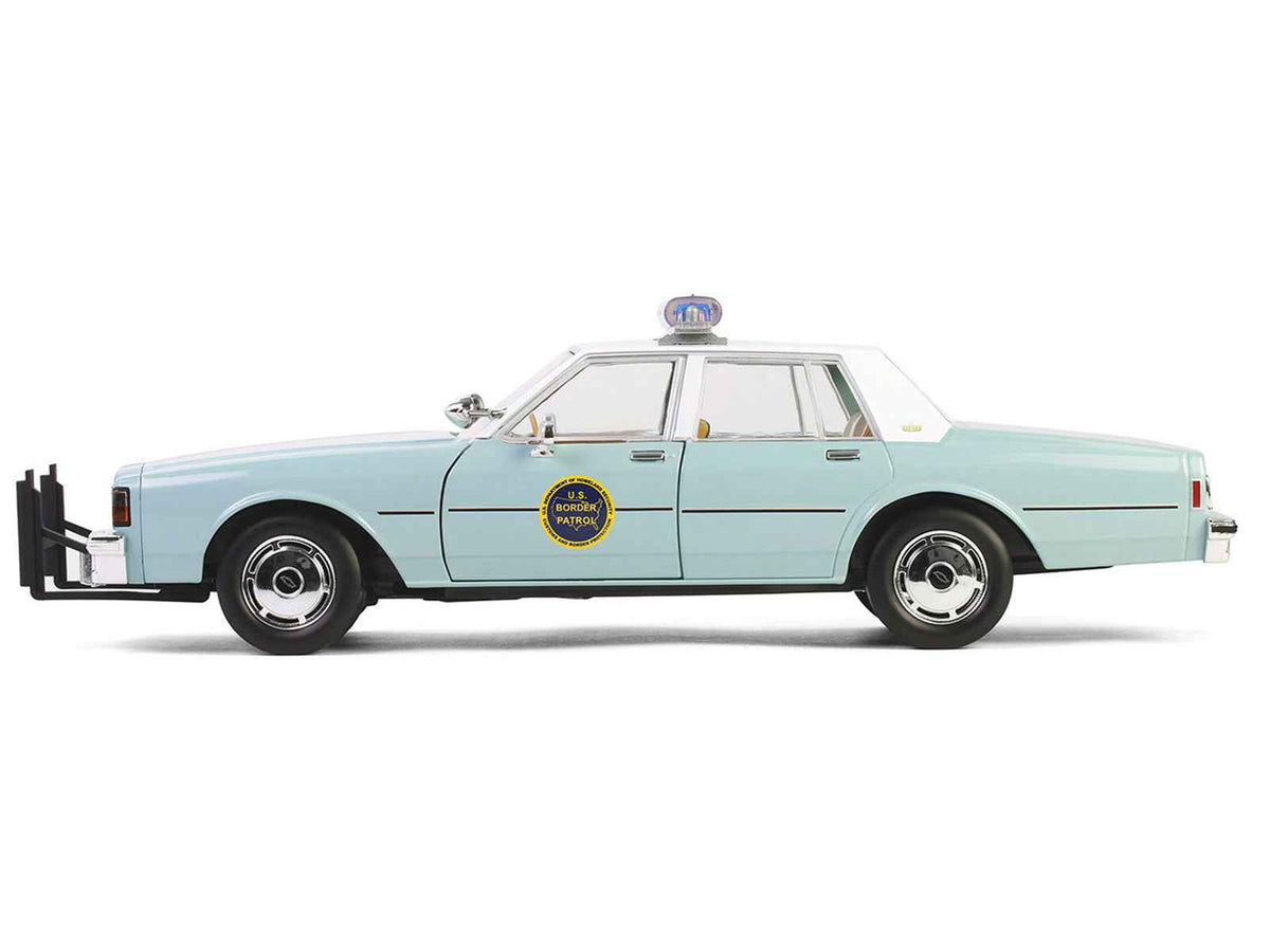 Greenlight 1/18 diecast model of 1987 Chevrolet Caprice 9C1 US Border Patrol car in light green with white top, part of Artisan Collection