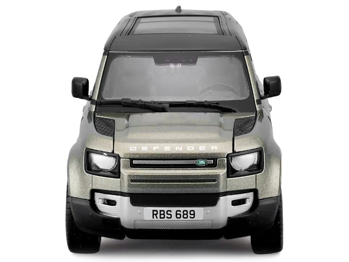 Green metallic 2022 Land Rover Defender 110 diecast model car with black roof and sunroof by Bburago, detailed miniature vehicle.