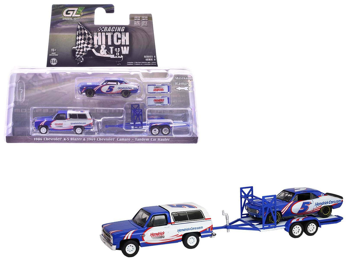 Miniature Motors 1/64 scale Chevrolet K5 Blazer and Camaro diecast model cars with tandem car trailer, blue and white color scheme.