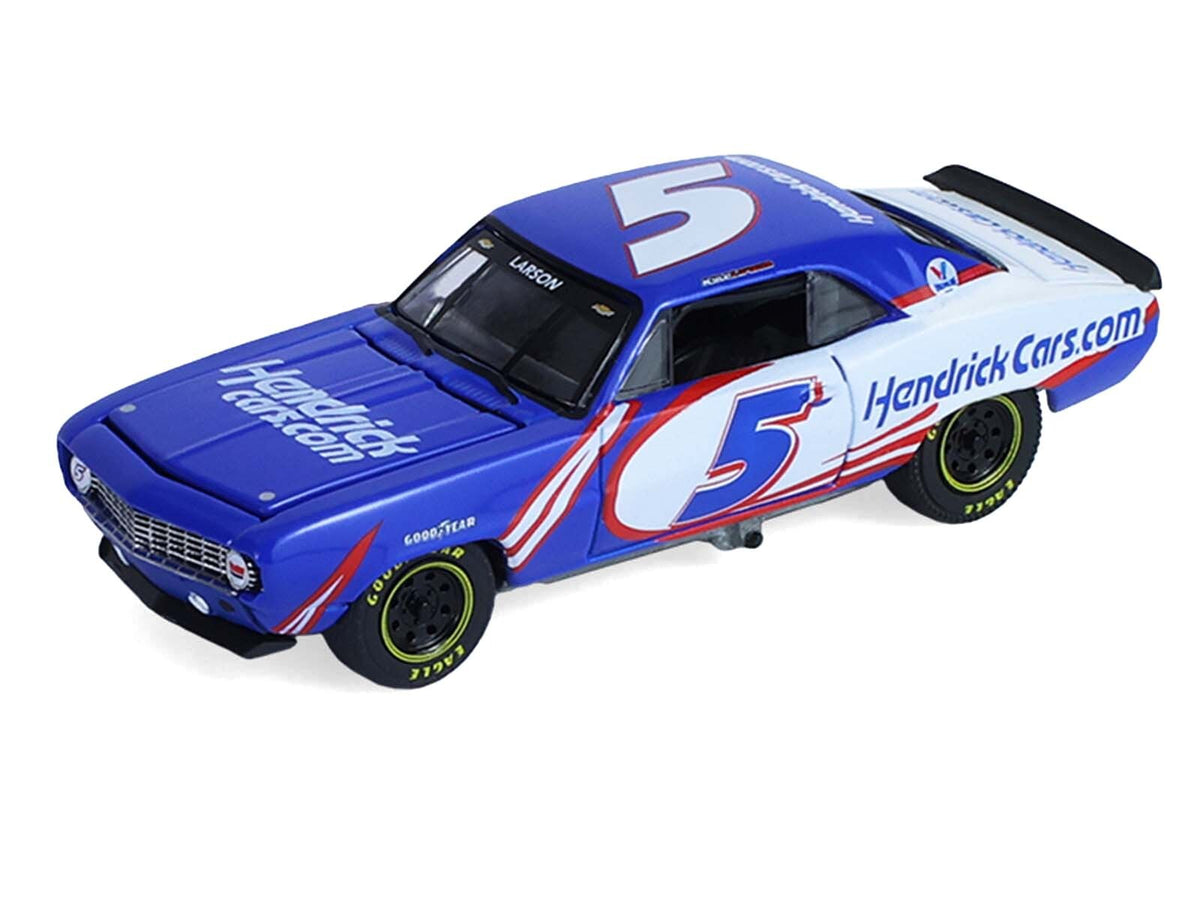 1/64 scale Chevrolet K5 Blazer and Camaro diecast model cars by Miniature Motors, featuring blue and white racing designs and tandem trailer.