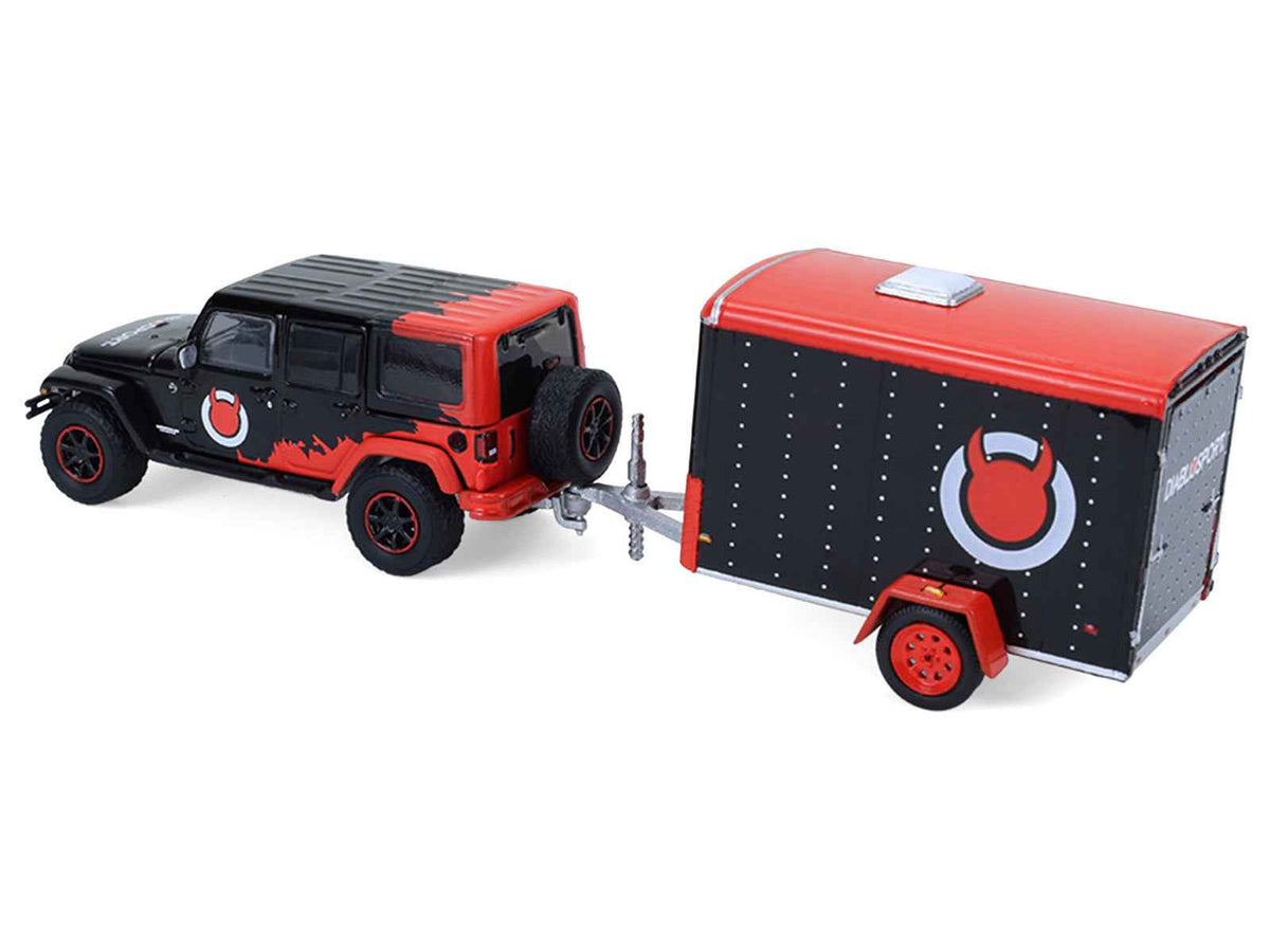 Miniature Motors 2012 Jeep Wrangler Unlimited Diablo Sport diecast model with black body, red graphics, and small cargo trailer.