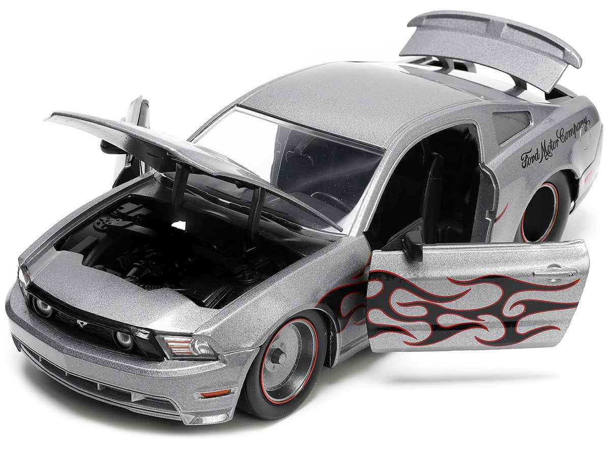 2010 Ford Mustang GT diecast model car in gray metallic with flame decals, from Miniature Motors' Bigtime Muscle series by Jada