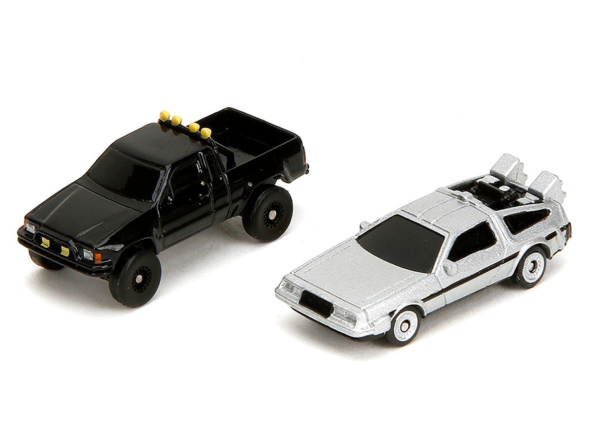 Miniature Motors Hill Valley Courthouse diorama with black pickup truck and DeLorean from "Back to the Future" movie series.