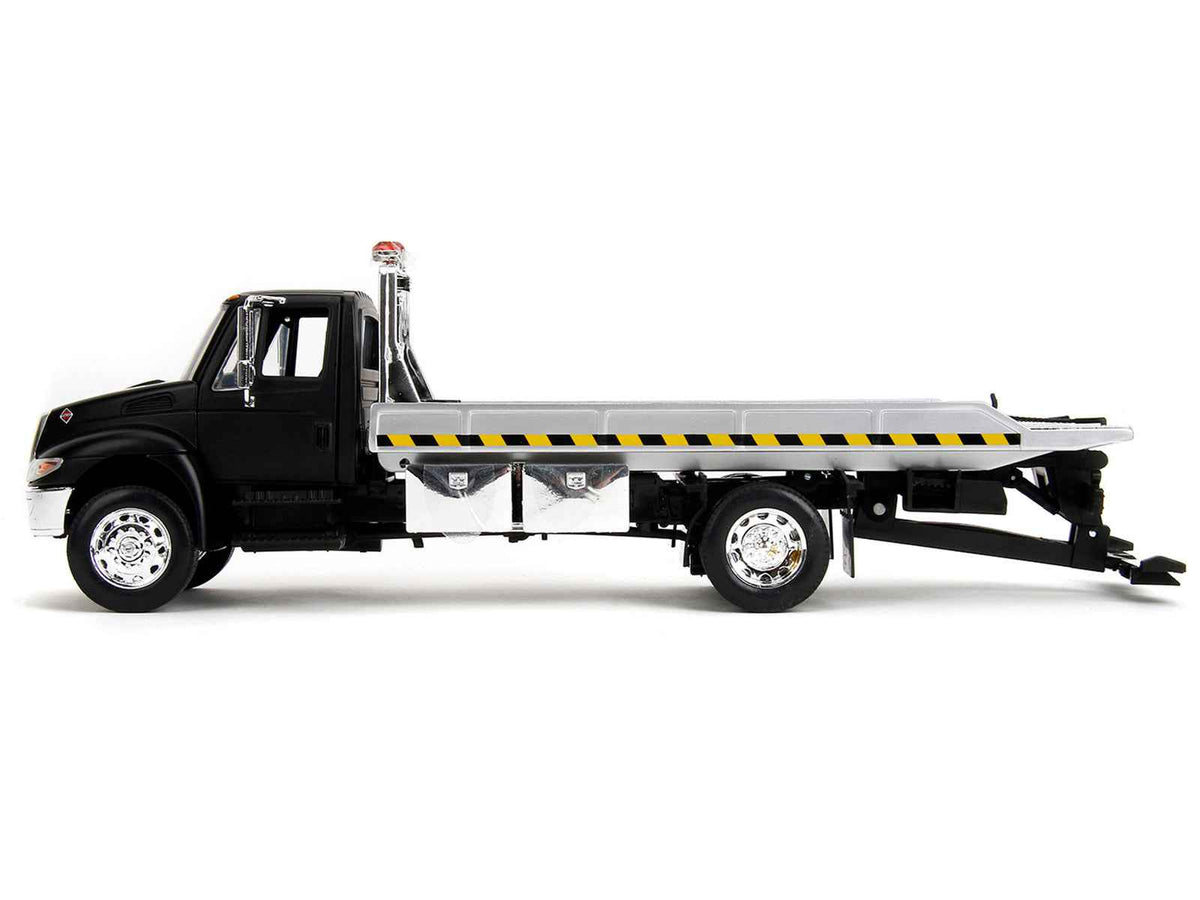 International DuraStar 4400 flatbed tow truck diecast model by Jada, matte black 1/24 scale International Models vehicle.