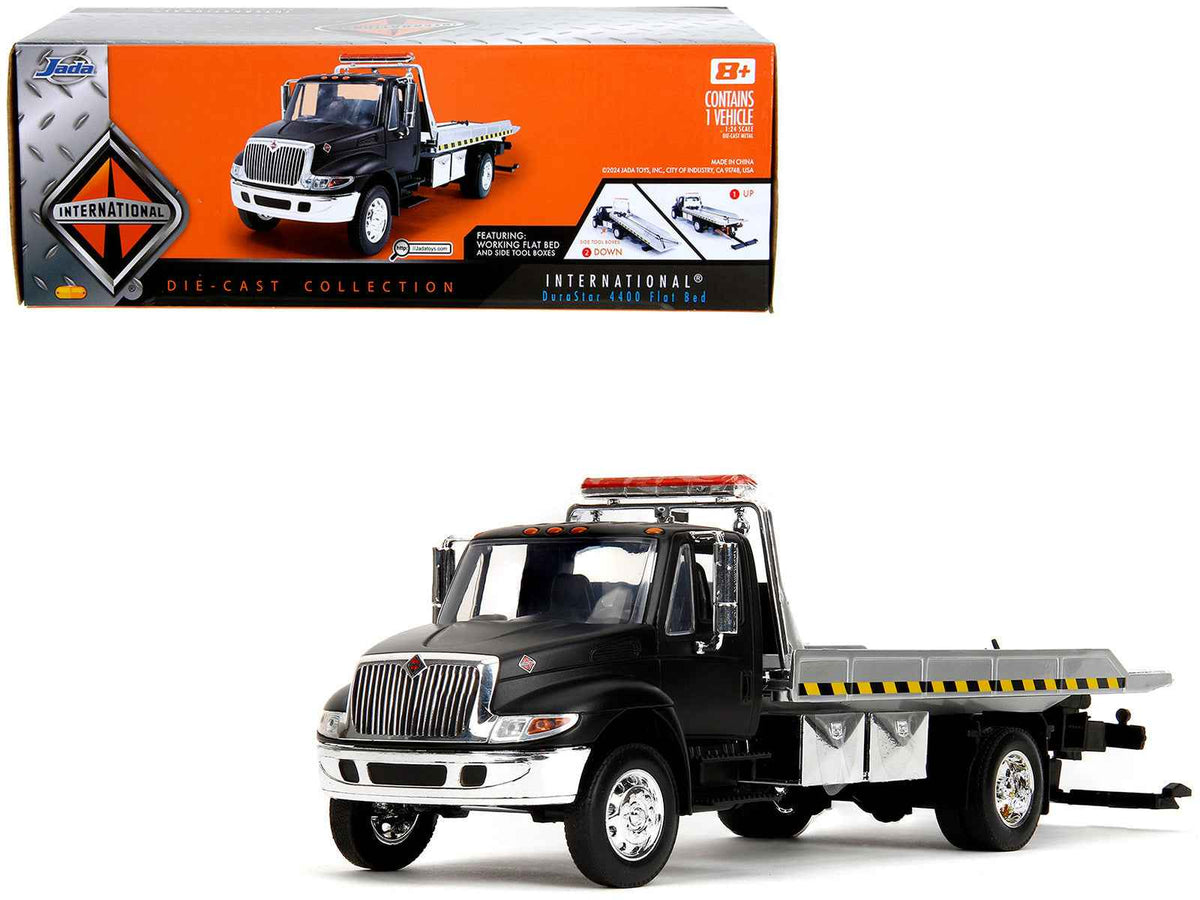 Miniature Motors International DuraStar 4400 flatbed tow truck diecast model in matte black, 1/24 scale by Jada.