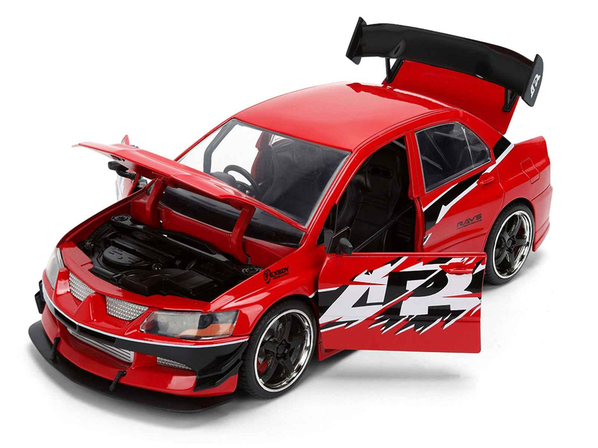 Red Mitsubishi Lancer Evolution IX RHD diecast model car by Miniature Motors, featuring "The Fast and the Furious: Tokyo Drift" graphics.