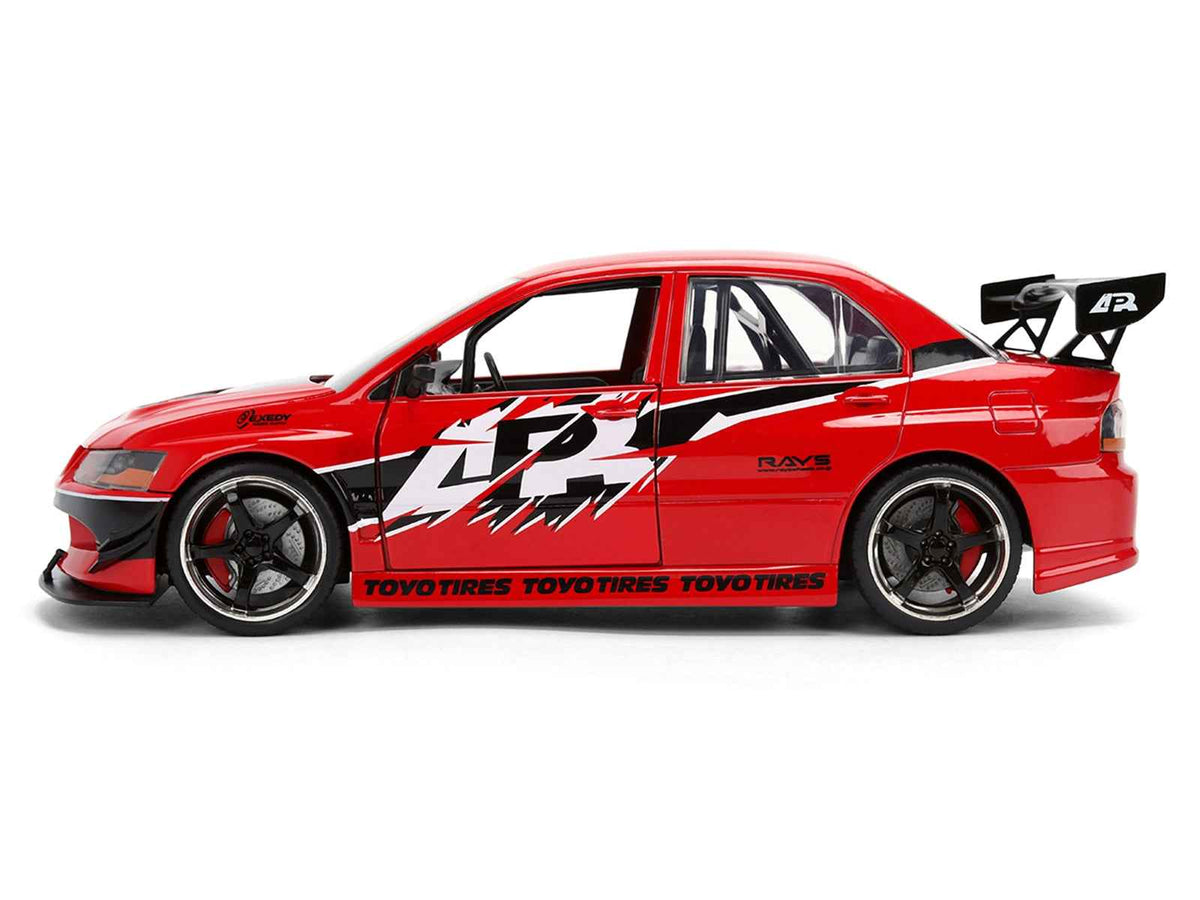 Red Mitsubishi Lancer Evolution IX RHD diecast model car with "Fast & Furious" graphics, from Miniature Motors' 1/24 series.