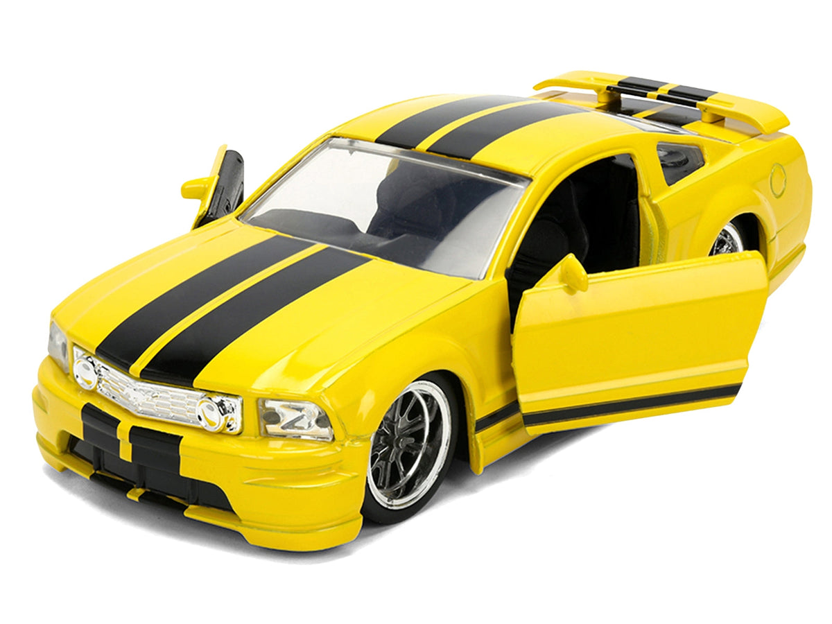 Yellow 2006 Ford Mustang GT diecast model with black stripes, part of the "Fast & Furious" 25 Years series by Jada.