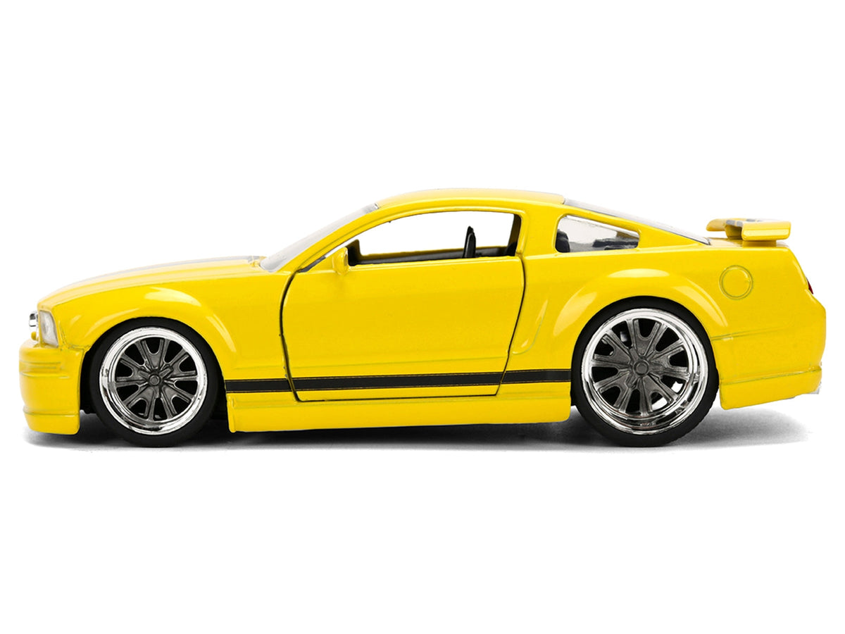 Yellow 2006 Ford Mustang GT diecast model with black stripes, "Fast & Furious 25 Years" series, by Jada, detailed miniature car.