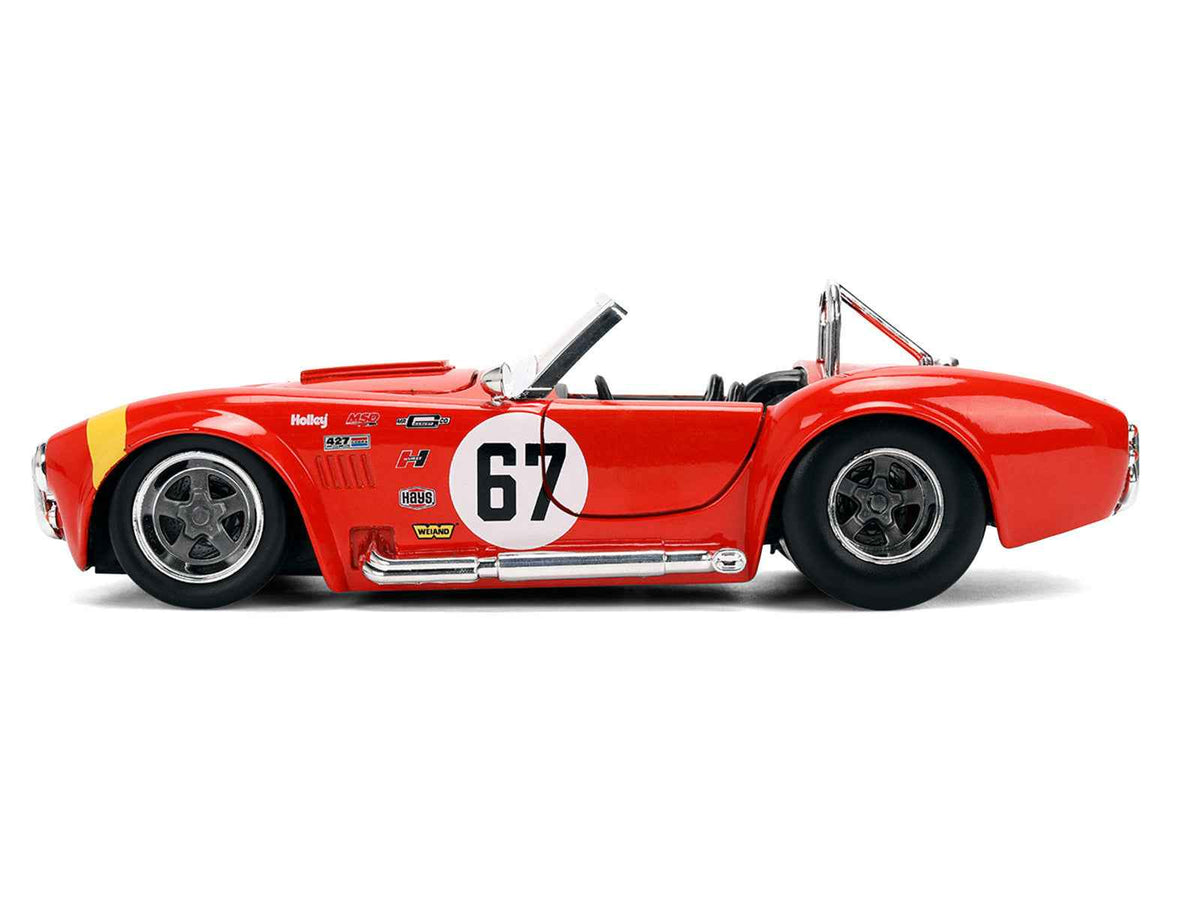 Red 1965 Shelby Cobra 427 S/C diecast model car with yellow stripe, part of Jada's Bigtime Muscle Series, Miniature Motors.