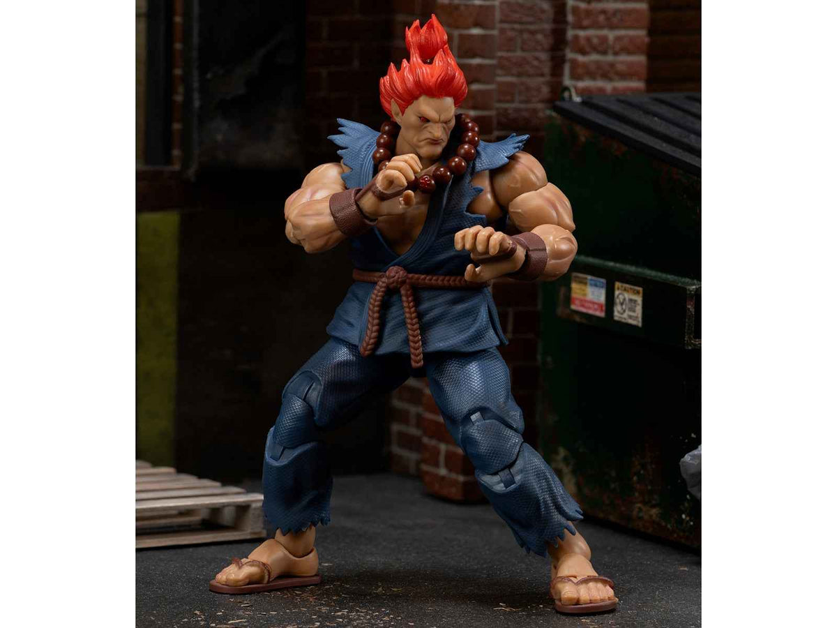 Akuma 6-inch movable figure by Miniature Motors from Street Fighter II, with accessories, alternate head, and hands, posed with game backdrop.