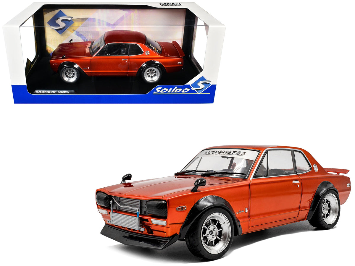 Orange metallic 1/18 scale Nissan Skyline C10 Hakosuka diecast model car by Solido, RHD, detailed miniature vehicle display.
