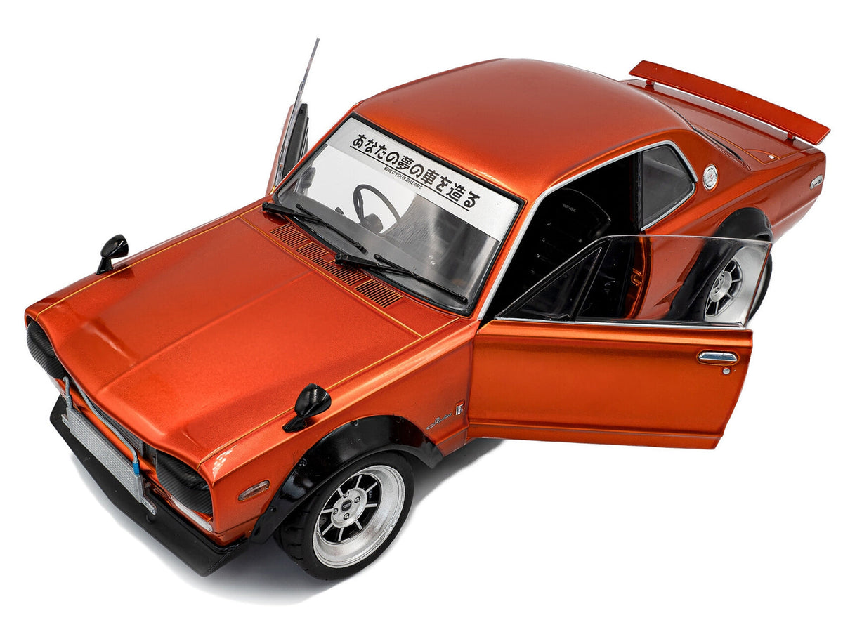 Orange metallic 1/18 scale Nissan Skyline C10 Hakosuka diecast model car by Solido, right-hand drive, detailed miniature toy.