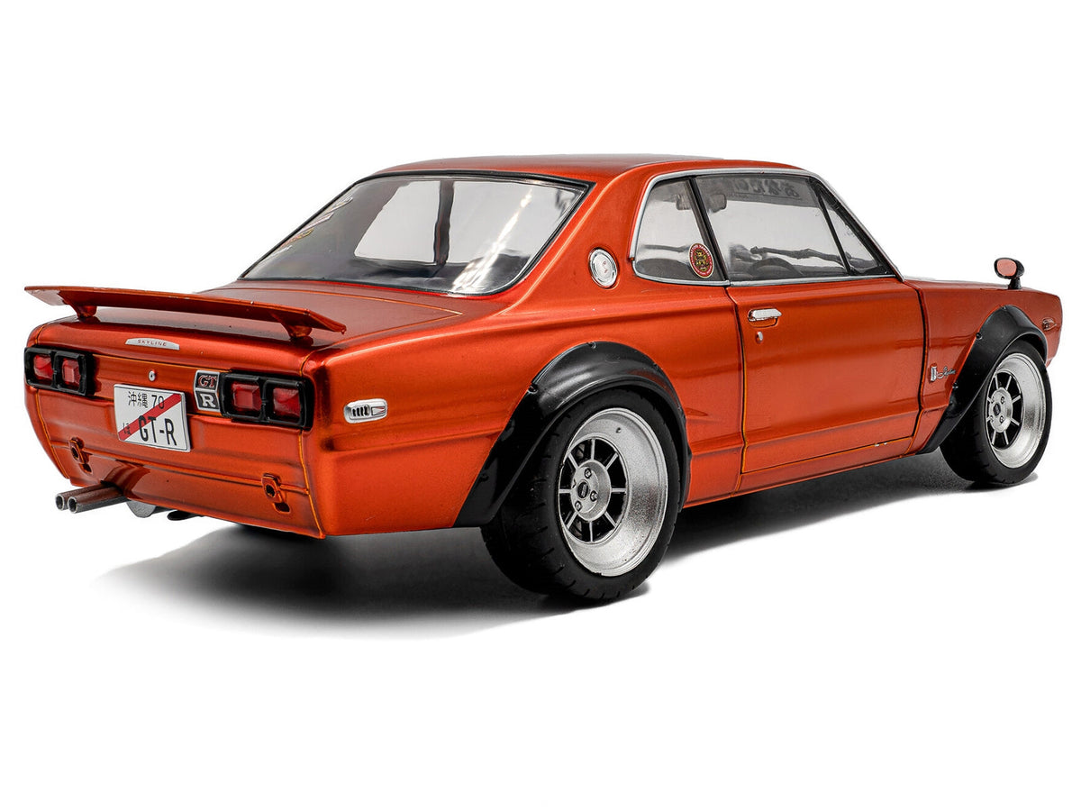 Orange metallic 1/18 diecast Nissan Skyline C10 Hakosuka model car by Solido, right-hand drive, detailed miniature vehicle.