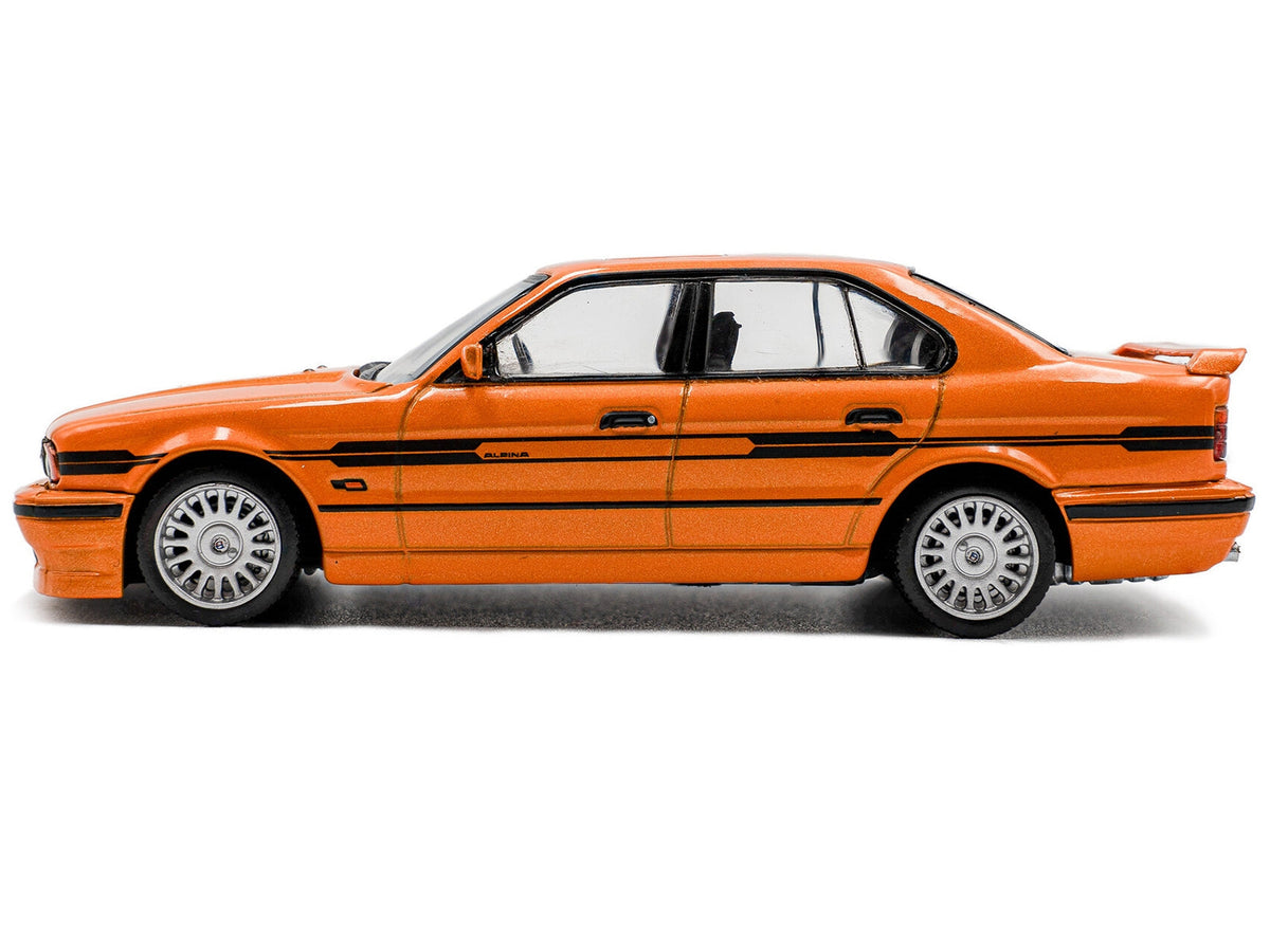Miniature BMW E34 Alpina B10 BiTurbo diecast model car in orange metallic with black stripes, detailed 1/43 scale by Solido.