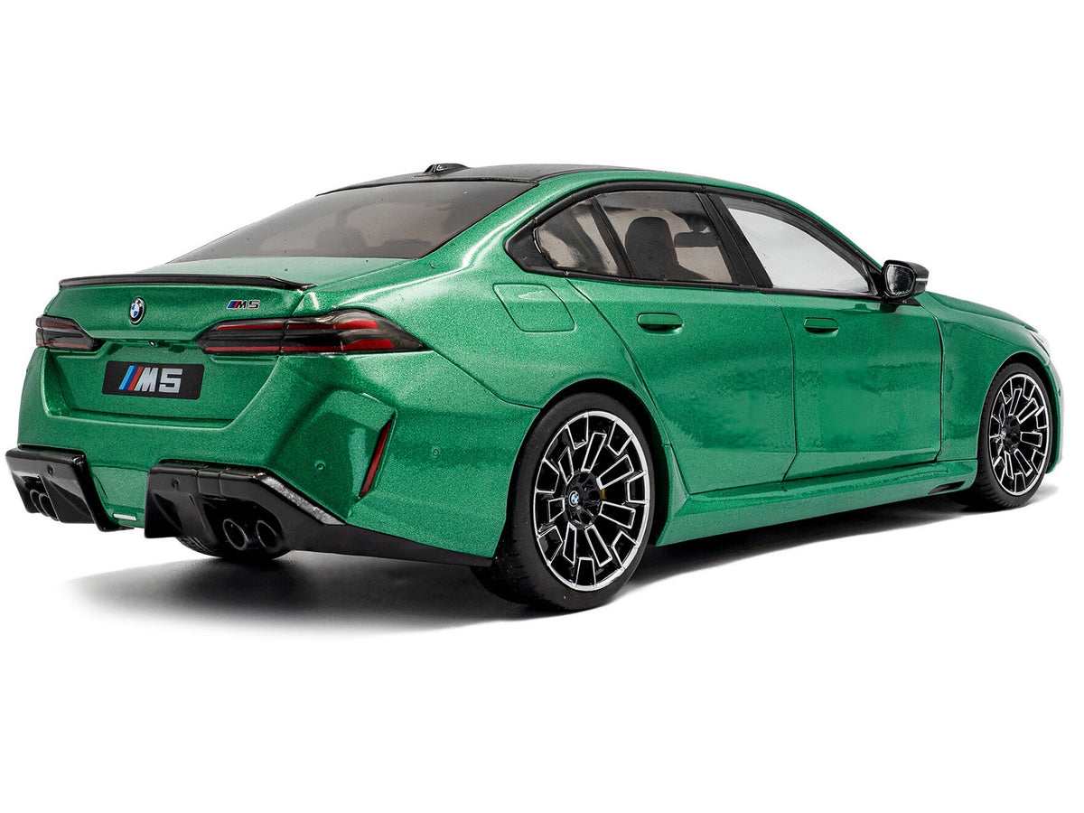 Miniature BMW M5 diecast model car in Isle of Man Green Metallic, 1/18 scale by Solido, detailed miniature vehicle for collectors.
