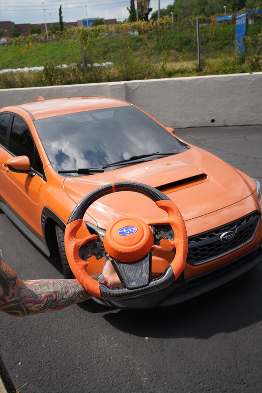 JDMuscle Ultimate Series steering wheel for 2022-2025 Subaru WRX, sporty design with black leather and silver accents.