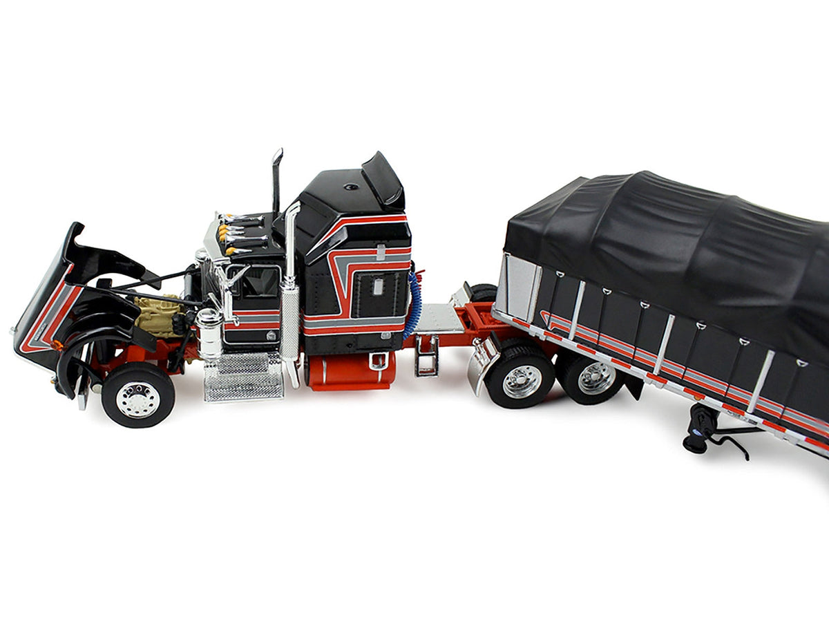 Miniature Motors Kenworth W900A model with 60" Aerodyne Sleeper and 53' Wilson Roadbrute Flatbed trailer, covered wagon black with red stripes.
