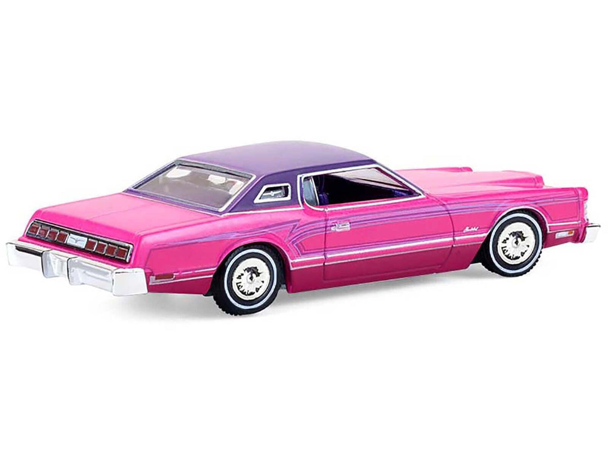 Miniature Ford Thunderbird 1975 lowrider diecast model in pink metallic with purple top, interior, and graphics by Greenlight.