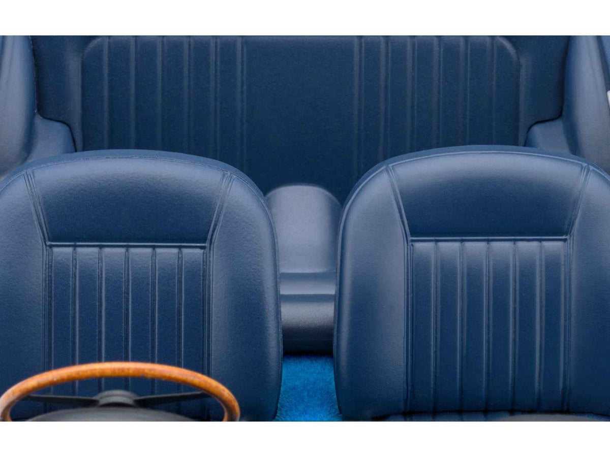 A detailed 1/18 scale Aston Martin DB5 RHD model car in Caribbean Pearl Blue Metallic by Autoart, displayed on a plain background.