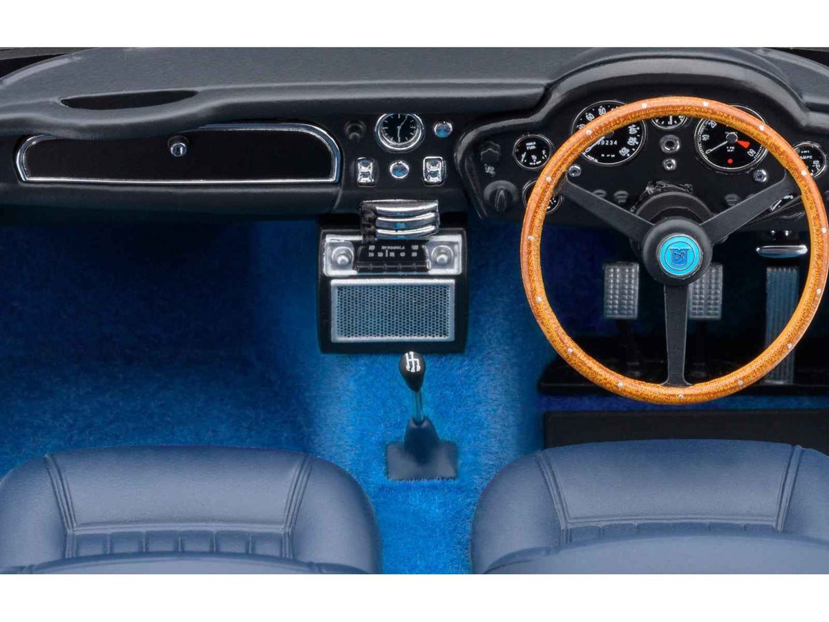 Miniature Aston Martin DB5 RHD model car in Caribbean Pearl Blue Metallic by Autoart, showcasing detailed 1/18 scale collectible.