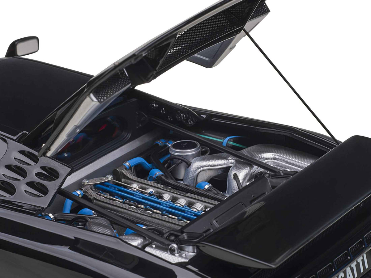 Miniature Bugatti EB110 SS Super Sport model car by Autoart, black with red interior and silver wheels, 1/18 scale.