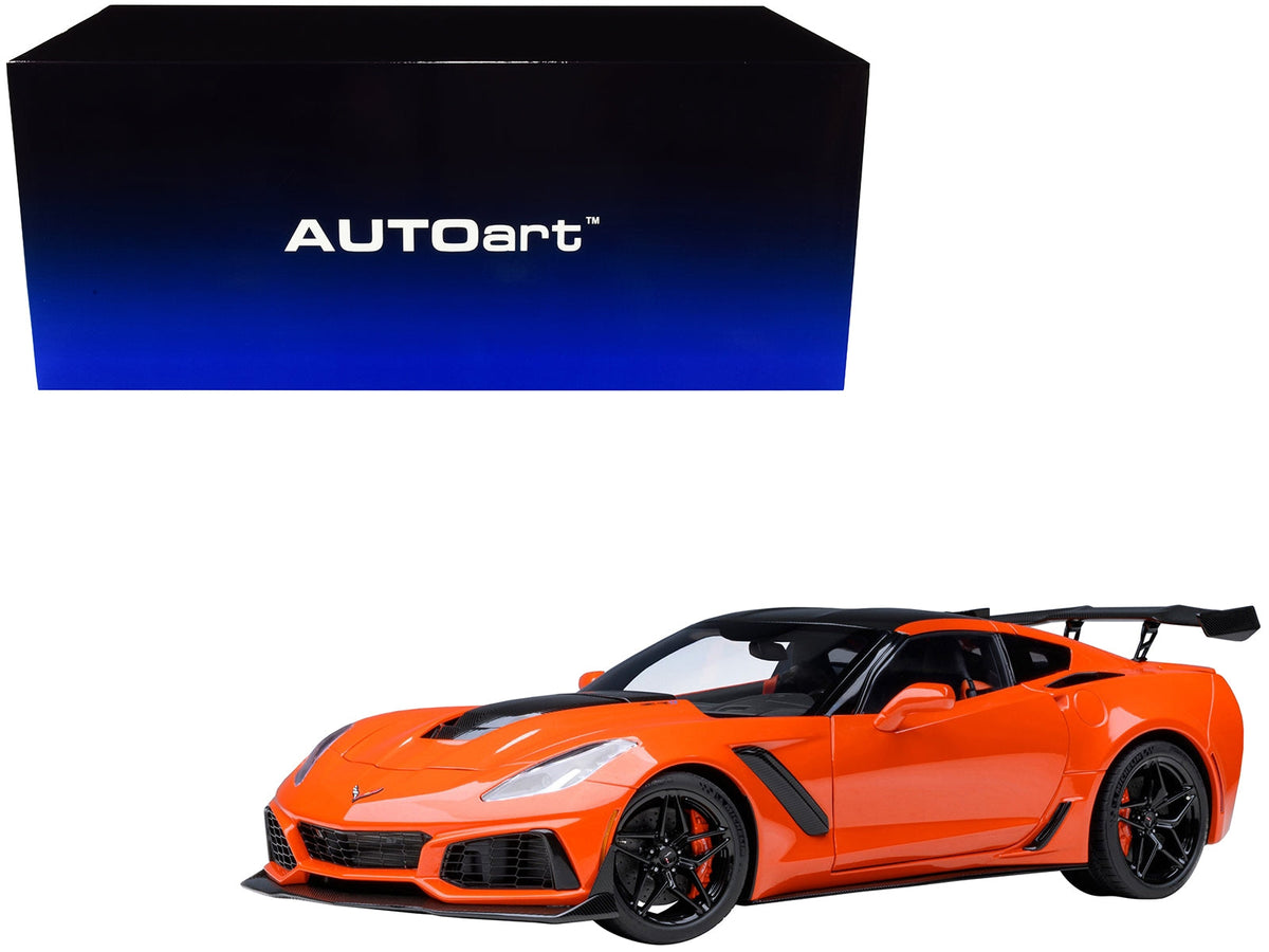 Miniature 1/18 Chevrolet Corvette C7 ZR1 model car in Sebring Orange Tintcoat with carbon top by Autoart, detailed collectible replica.