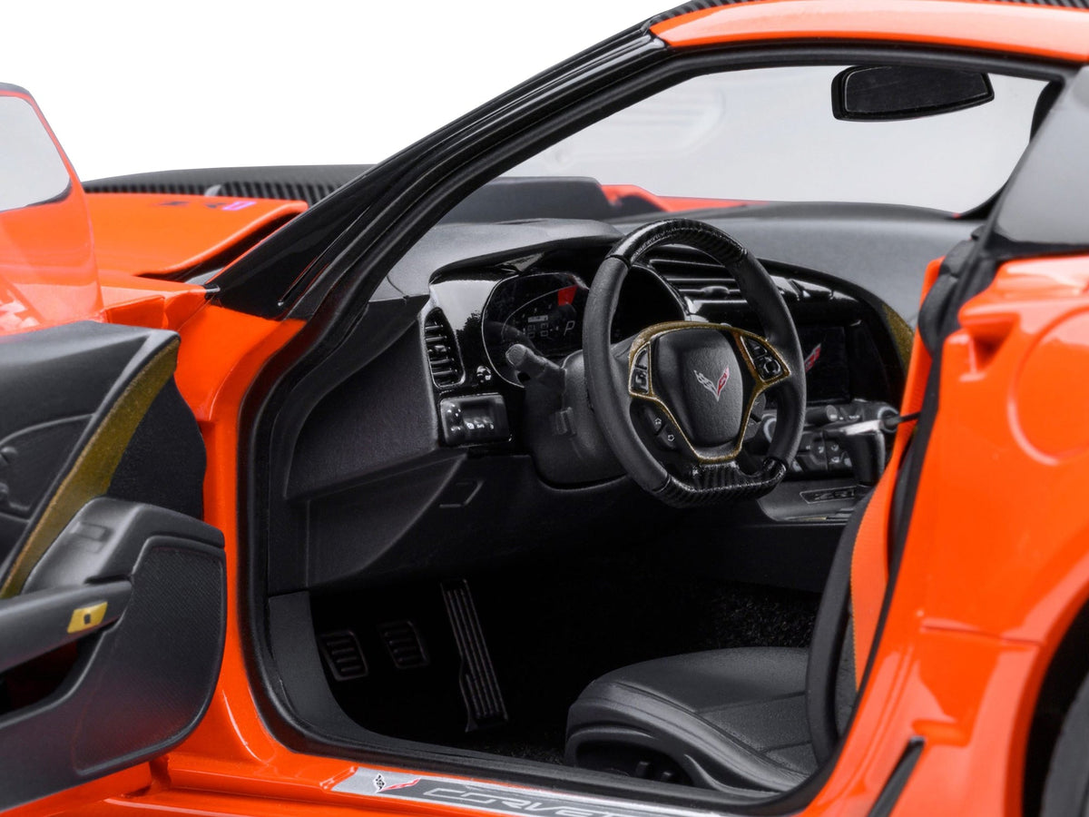 Miniature Motors 2019 Chevrolet Corvette C7 ZR1 model car in Sebring Orange Tintcoat with carbon top, detailed 1/18 scale collectible.