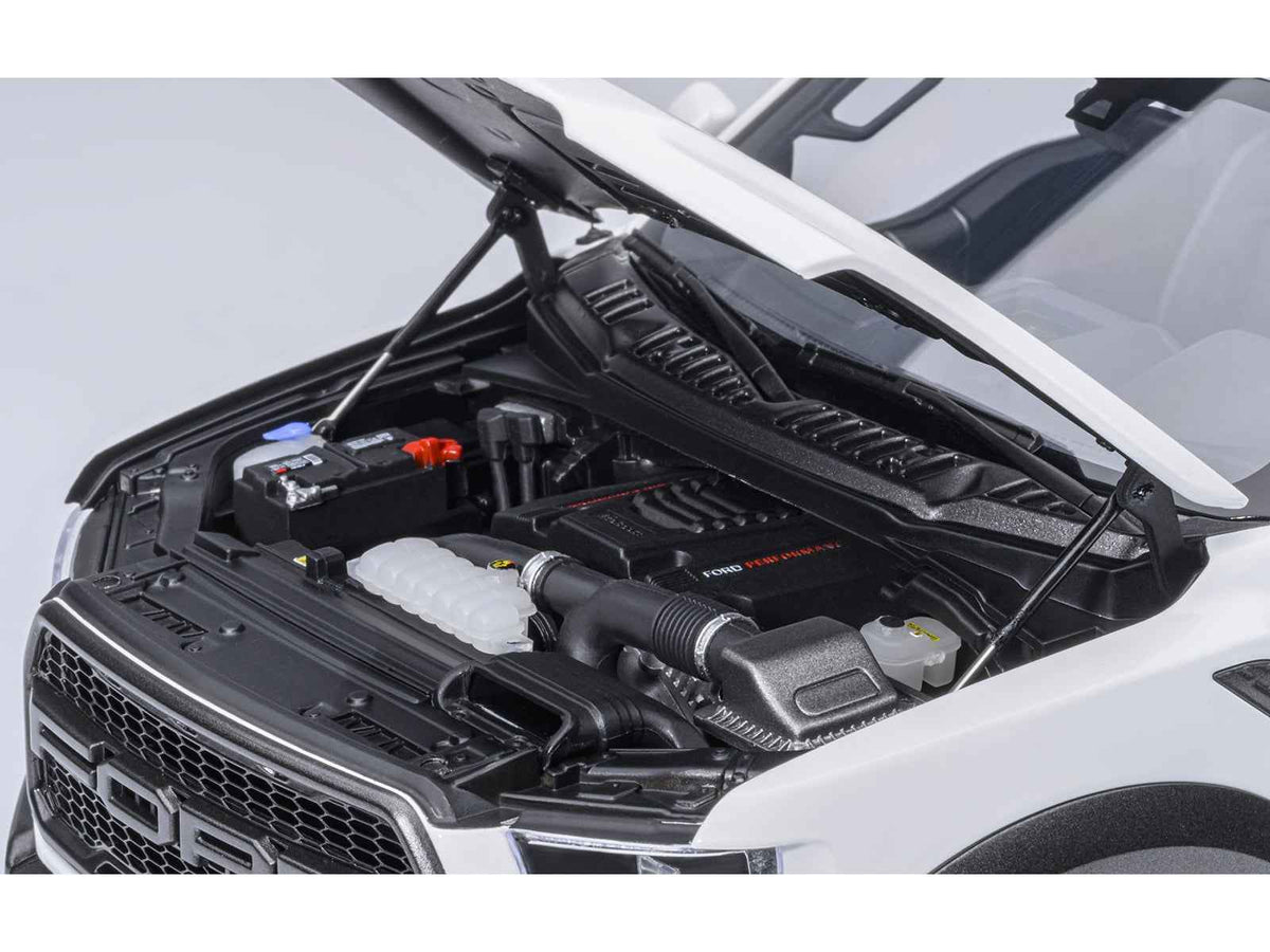 Miniature Ford F-150 Raptor 2019 pickup truck model in Oxford White by Autoart, detailed 1/18 scale collectible car.