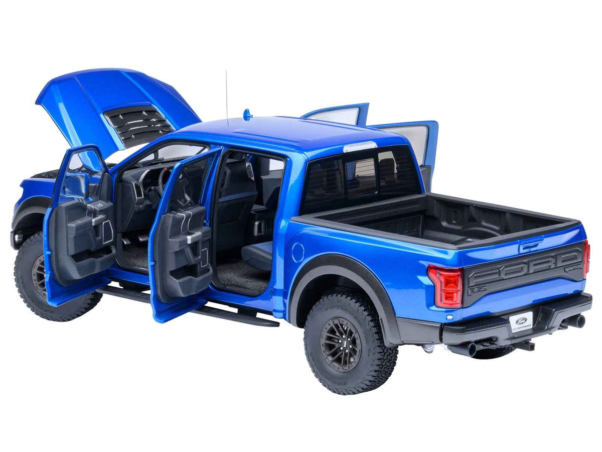 Miniature Motors 1/18 scale Ford F-150 Raptor pickup truck model in velocity blue by Autoart, detailed collectible car replica.