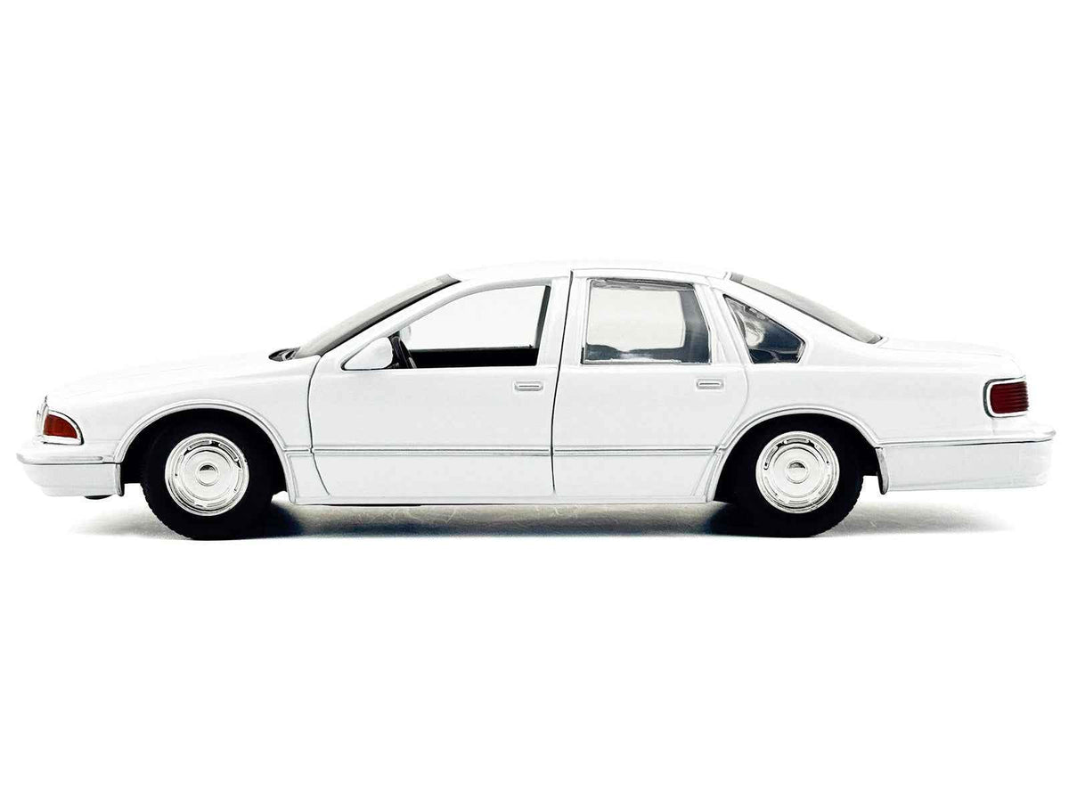 Miniature Motors 1/24 diecast Chevrolet Caprice police car model in unmarked white, part of the Custom Builder's Kit series.