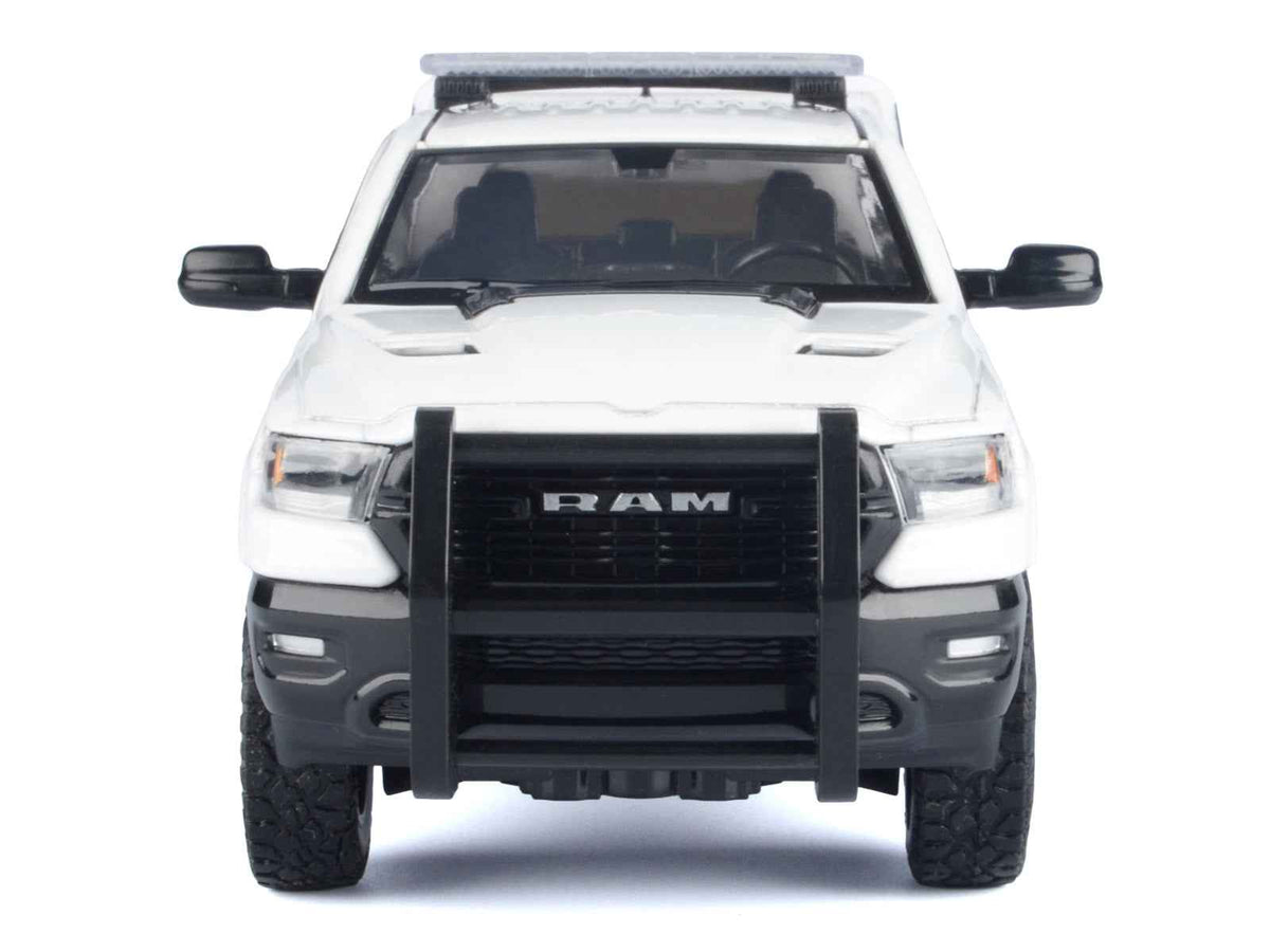White 2019 RAM 1500 Laramie Crew Cab diecast model truck by Miniature Motors, detailed with truck bed camper, series 1/27.