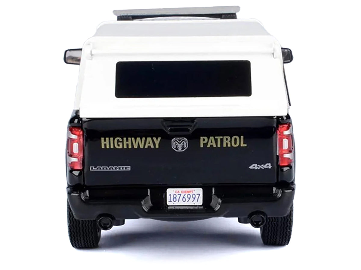 Miniature Motors RAM 1500 Laramie Crew Cab Pickup Truck diecast model in black and white with CHP markings and truck bed camper.