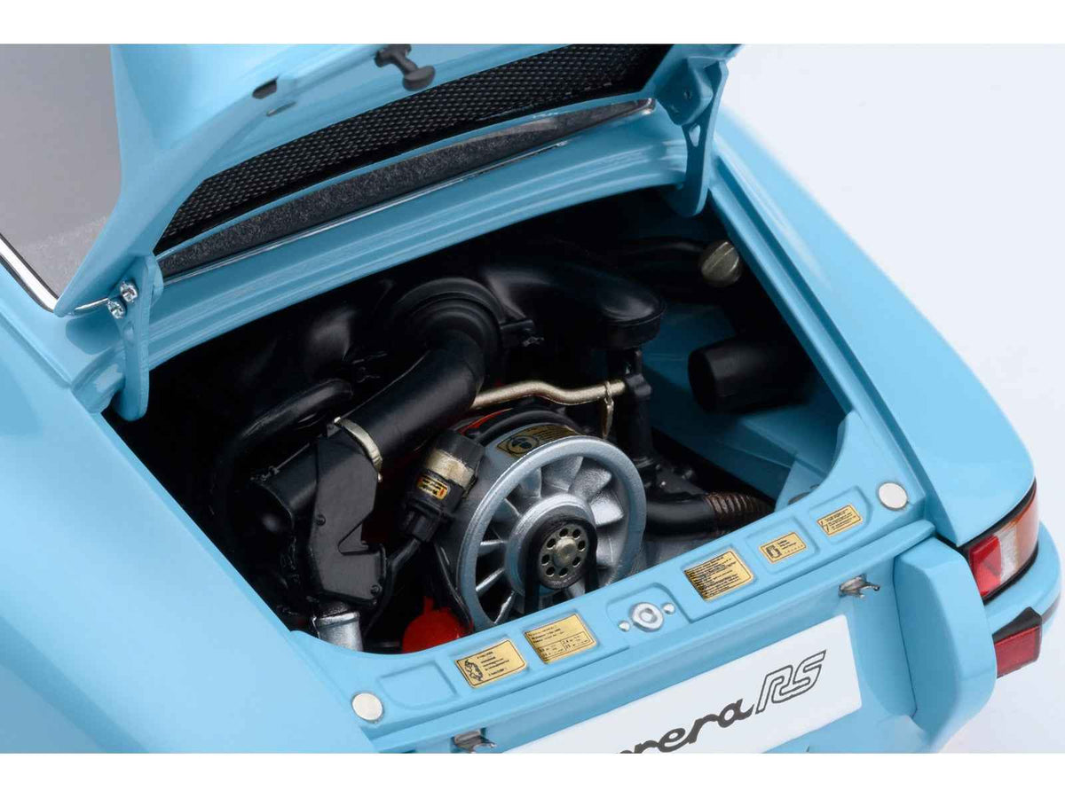 Miniature Porsche 911 Carrera 2.7 RS model car in Gulf Blue with black stripes and wheels, detailed 1/18 scale by Autoart.