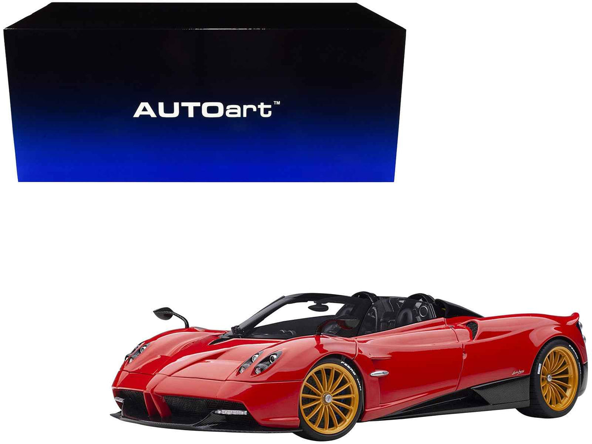 Miniature Pagani Huayra Roadster model car in Rosso Monza red with carbon details and luggage set, 1/18 scale by Autoart.