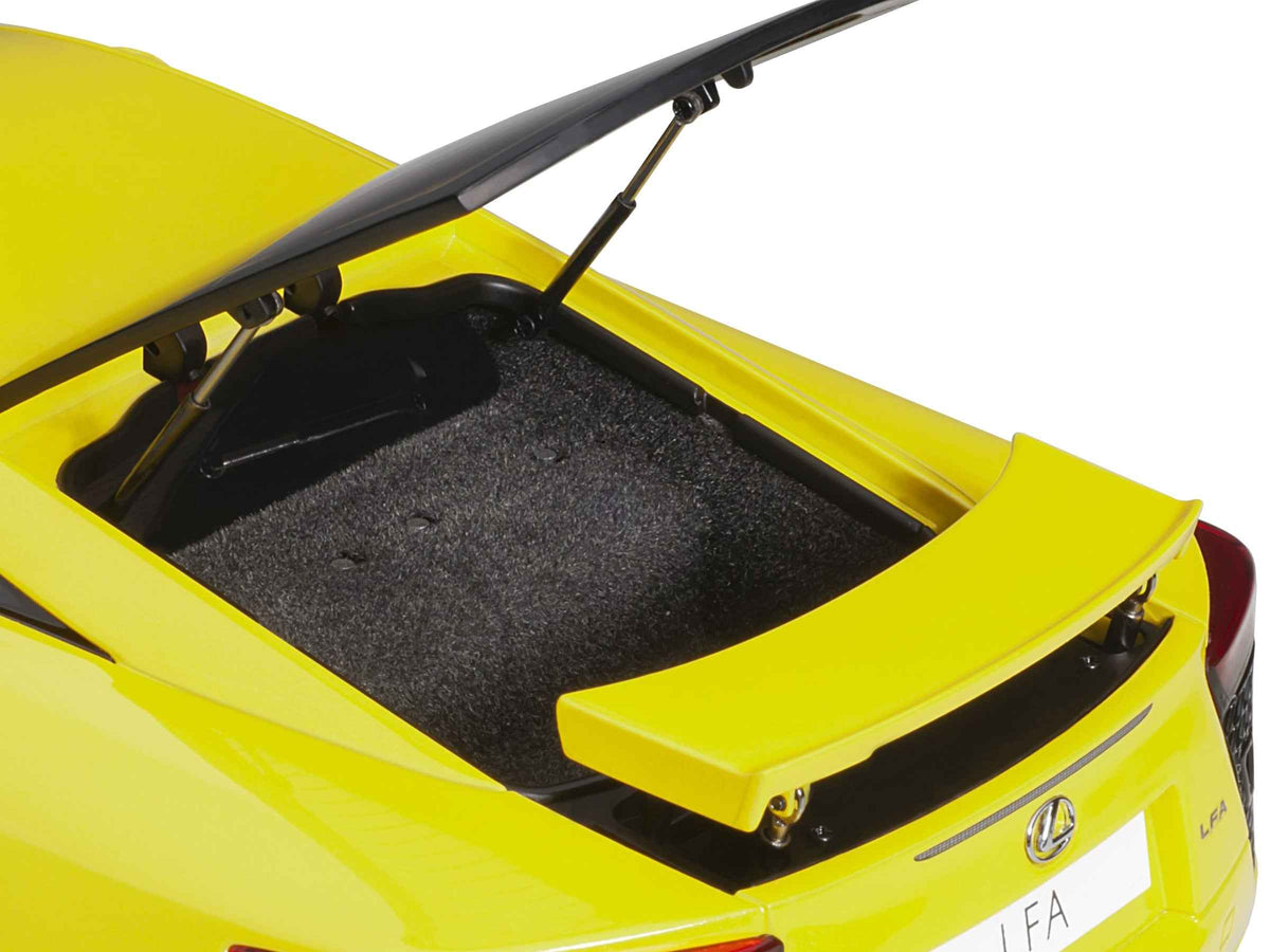 Lexus LFA Pearl Yellow 1/18 scale model car by Autoart, featuring red and black interior, detailed miniature Lexus model.