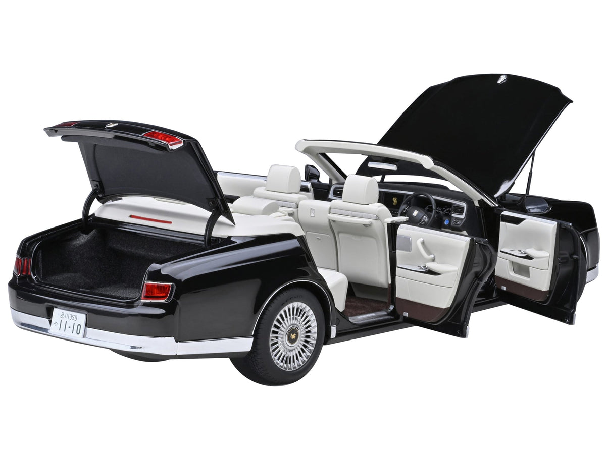 Black Toyota Century open convertible model car by Autoart, right-hand drive with white interior, 1/18 scale miniature.