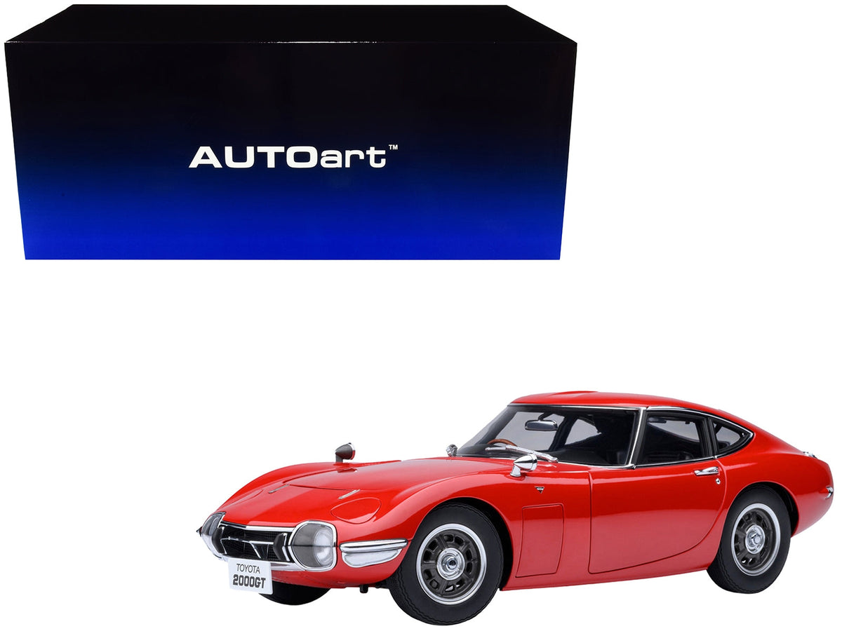 Red 1/18 scale Toyota 2000GT RHD model car by Autoart, detailed miniature replica of the classic 1967 Toyota sports car.
