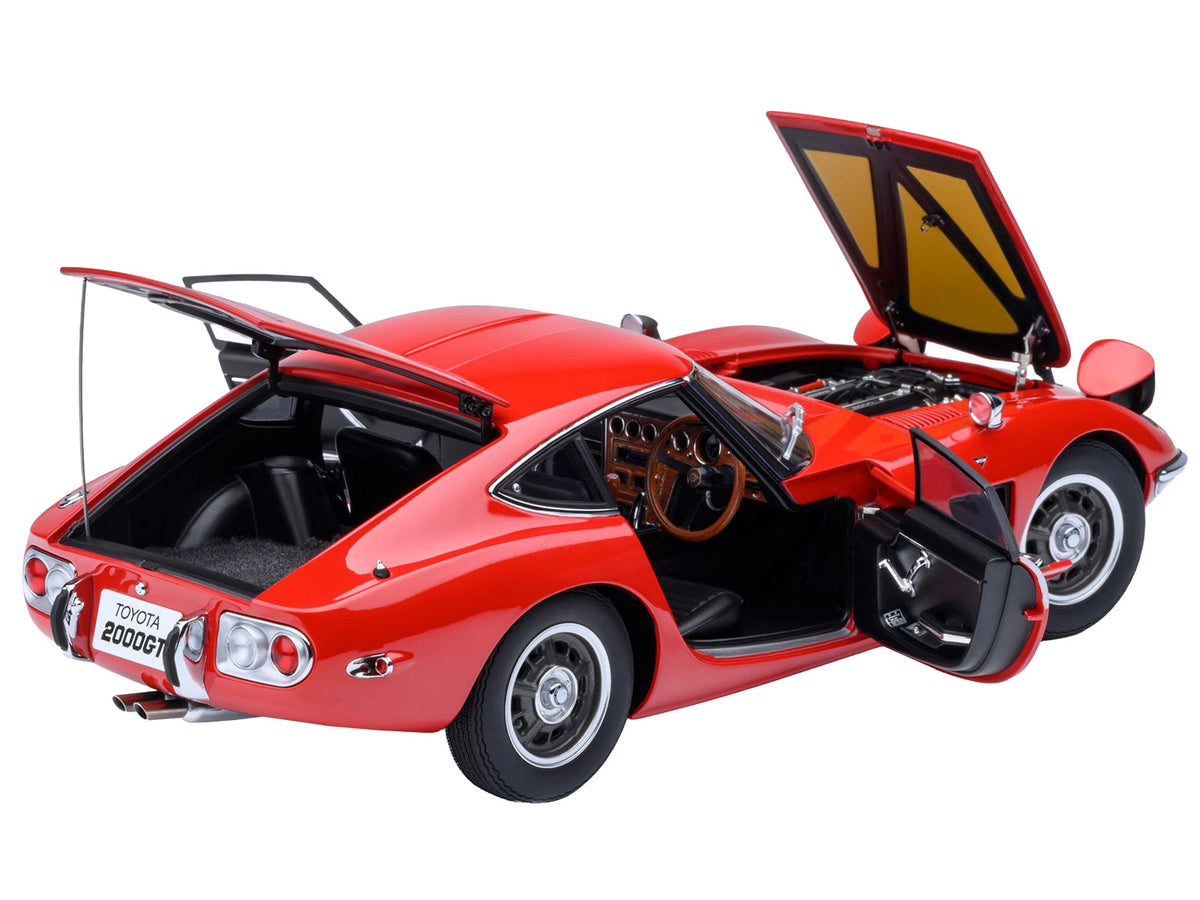 Red 1967 Toyota 2000GT RHD model car by Autoart, 1/18 scale Toyota model in miniature, detailed right-hand drive collectible.
