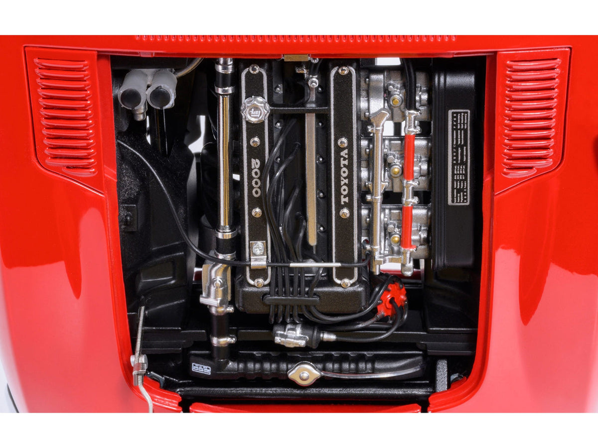 Red 1967 Toyota 2000GT RHD model car in 1/18 scale by Autoart, showcasing detailed miniature Toyota car with right-hand drive.